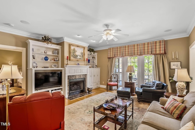 955 Sagamore Dr, Louisburg, NC 27549 - living room with baseboards, ornamental molding, a ceiling fan, light wood finished floors, and a premium fireplace