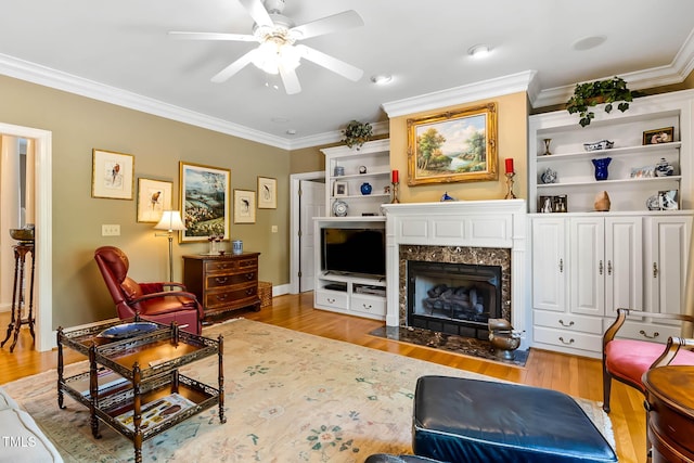 955 Sagamore Dr, Louisburg, NC 27549 - living room featuring crown molding, wood finished floors, a premium fireplace, and a ceiling fan