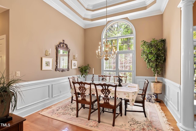 955 Sagamore Dr, Louisburg, NC 27549 - dining space featuring light wood-style flooring, a raised ceiling, ornamental molding, and a wainscoted wall