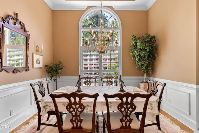 955 Sagamore Dr, Louisburg, NC 27549 - dining space featuring crown molding, wainscoting, an inviting chandelier, and wood finished floors
