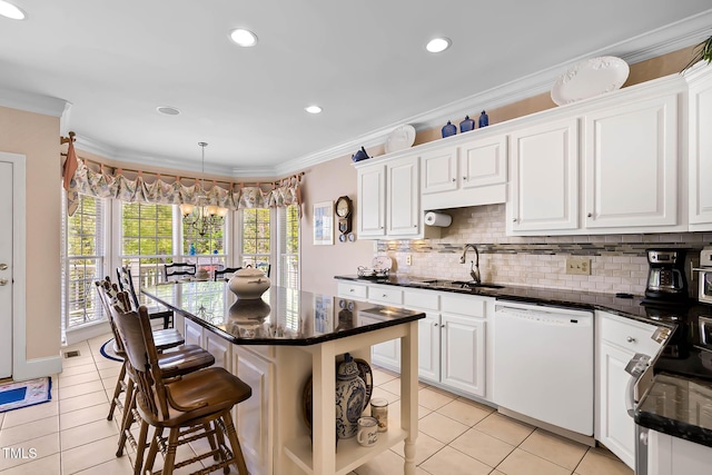 955 Sagamore Dr, Louisburg, NC 27549 - kitchen with dishwasher, a sink, white cabinetry, backsplash, and light tile patterned flooring