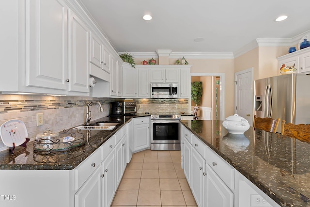 955 Sagamore Dr, Louisburg, NC 27549 - kitchen with tasteful backsplash, light tile patterned floors, white cabinets, appliances with stainless steel finishes, and a sink