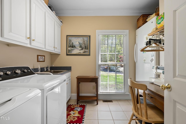955 Sagamore Dr, Louisburg, NC 27549 - clothes washing area with a sink, ornamental molding, independent washer and dryer, cabinet space, and light tile patterned flooring