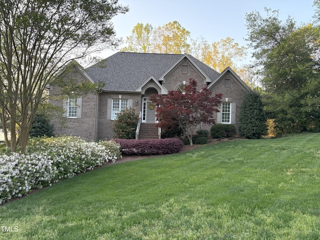 955 Sagamore Dr, Louisburg, NC 27549 - ranch-style house featuring roof with shingles, a front lawn, and brick siding