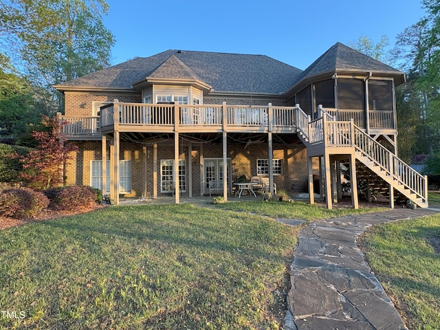 955 Sagamore Dr, Louisburg, NC 27549 - back of house with a sunroom, a yard, brick siding, stairs, and a deck