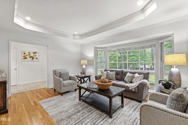 4902 Brookhaven Dr, Raleigh, NC 27612 - living area featuring a tray ceiling, crown molding, light wood-style floors, plenty of natural light, and recessed lighting