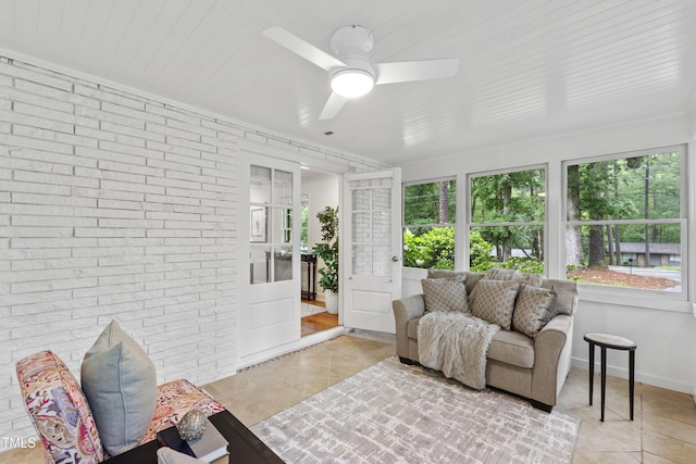 4902 Brookhaven Dr, Raleigh, NC 27612 - sunroom featuring tile patterned flooring, brick wall, and baseboards