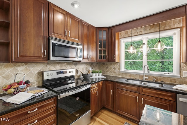 4902 Brookhaven Dr, Raleigh, NC 27612 - kitchen with stainless steel appliances, a sink, and dark stone countertops
