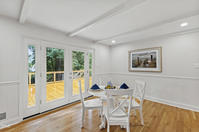 4902 Brookhaven Dr, Raleigh, NC 27612 - dining room featuring french doors, beam ceiling, light wood finished floors, and wainscoting