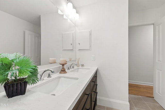 4902 Brookhaven Dr, Raleigh, NC 27612 - full bath featuring tile patterned flooring, double vanity, and baseboards