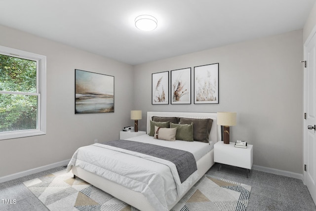 bedroom with baseboards and carpet flooring