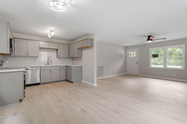 kitchen with tasteful backsplash, gray cabinets, ceiling fan, appliances with stainless steel finishes, and visible vents