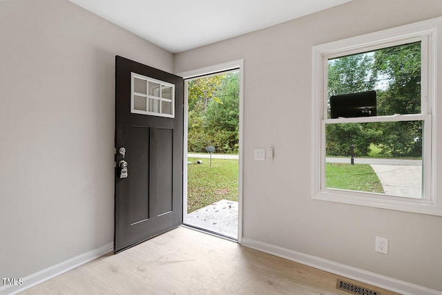entryway with light wood-style floors, visible vents, and baseboards