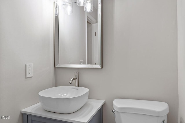 half bathroom featuring toilet and vanity