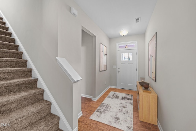 219 Zante Currant Rd, Durham, NC 27703 - entryway featuring light wood-style floors, baseboards, visible vents, and stairway