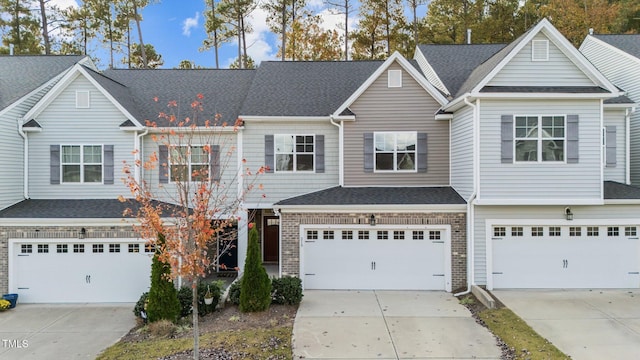 219 Zante Currant Rd, Durham, NC 27703 - view of property featuring driveway, a shingled roof, and a garage