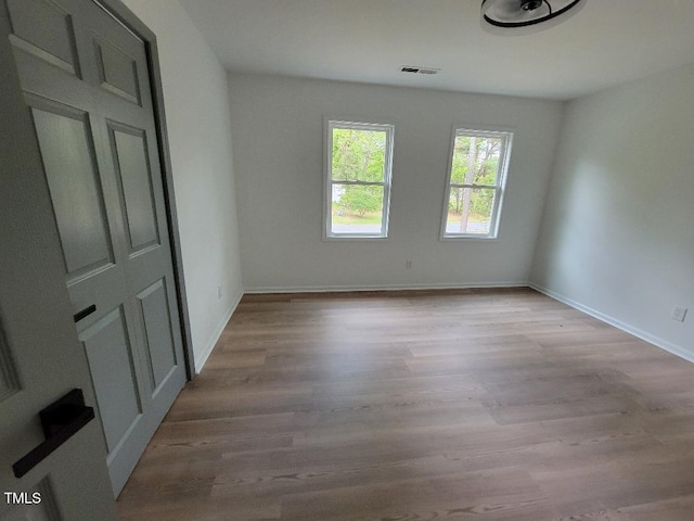 unfurnished bedroom featuring wood finished floors and baseboards