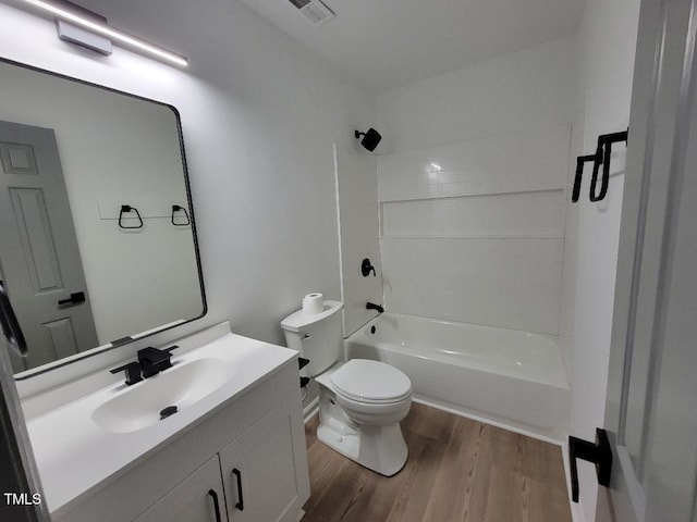 full bath with wood finished floors, toilet, vanity, and bathtub / shower combination