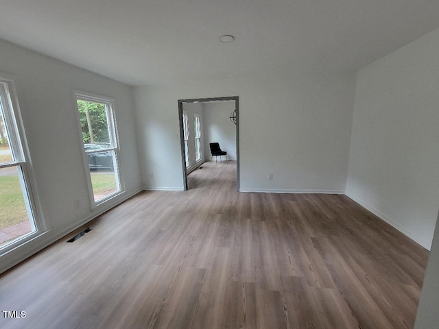 unfurnished room featuring wood finished floors and baseboards