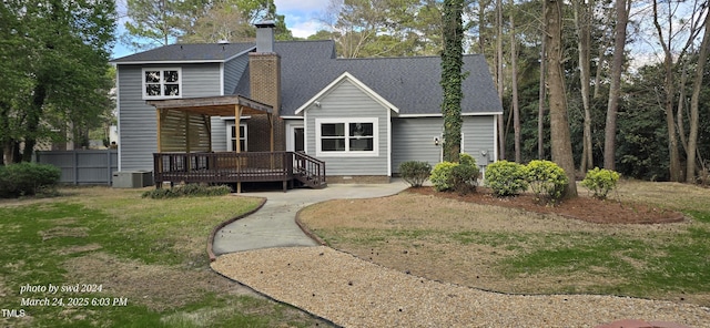 back of property with a wooden deck, cooling unit, and a chimney