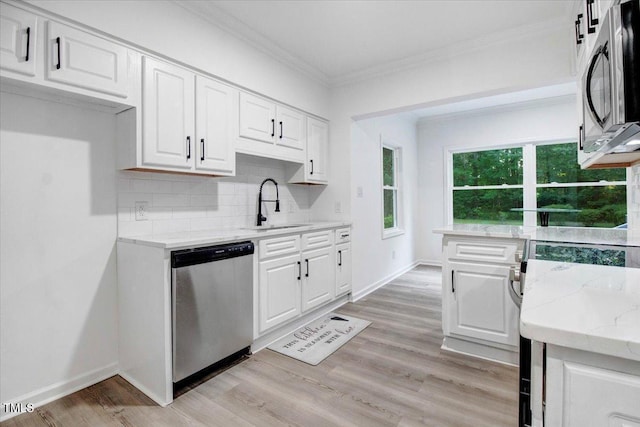 1506 Darby Rd, Goldsboro, NC 27534 - kitchen featuring appliances with stainless steel finishes, light stone counters, white cabinets, decorative backsplash, and crown molding