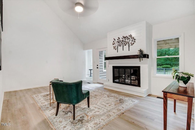 1506 Darby Rd, Goldsboro, NC 27534 - living room with light wood-style flooring, lofted ceiling, a ceiling fan, and a large fireplace