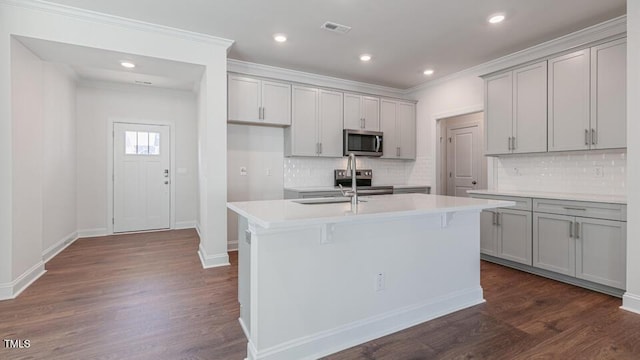 2318 Sugar Cone Way, Fuquay Varina, NC 27526 - kitchen featuring gray cabinetry, dark wood-type flooring, and appliances with stainless steel finishes