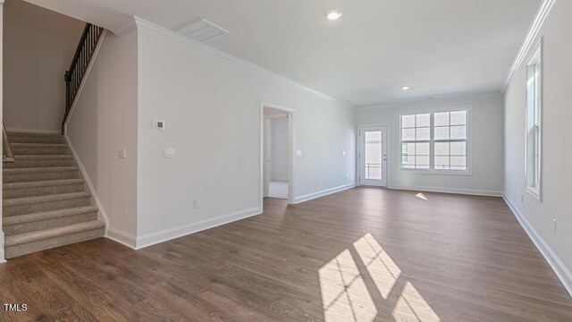 2318 Sugar Cone Way, Fuquay Varina, NC 27526 - unfurnished living room featuring dark wood-type flooring, ornamental molding, and stairway