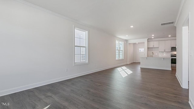2318 Sugar Cone Way, Fuquay Varina, NC 27526 - unfurnished living room featuring crown molding, baseboards, dark wood-style floors, and visible vents