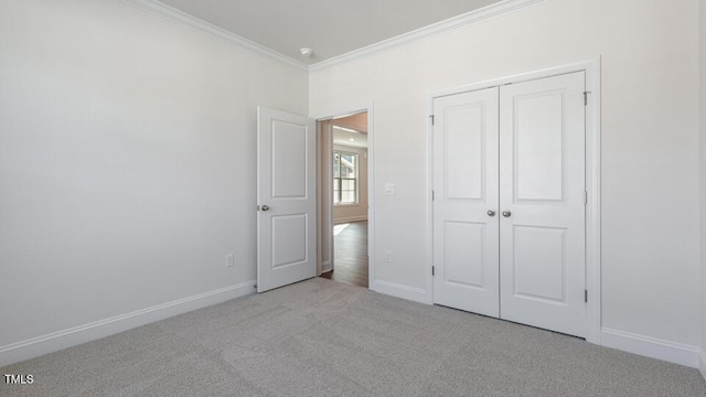 2318 Sugar Cone Way, Fuquay Varina, NC 27526 - unfurnished bedroom featuring a closet, baseboards, ornamental molding, and carpet floors