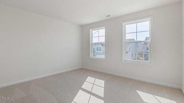 2318 Sugar Cone Way, Fuquay Varina, NC 27526 - spare room with baseboards and light colored carpet
