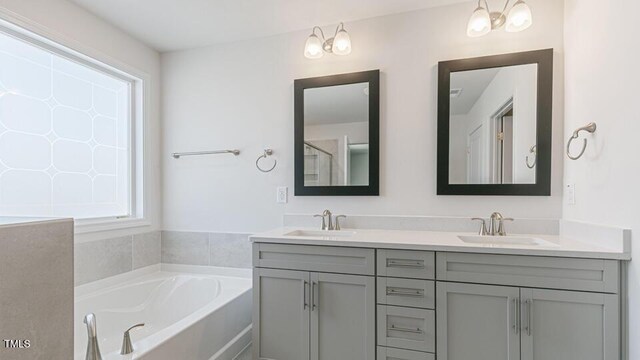 2318 Sugar Cone Way, Fuquay Varina, NC 27526 - full bath with double vanity, a garden tub, and a sink
