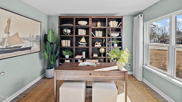 office area with wood finished floors and baseboards