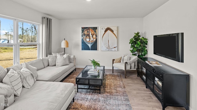 living room featuring light wood-style flooring and baseboards