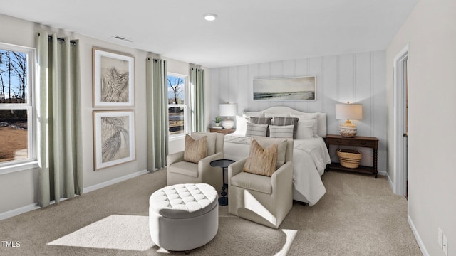 bedroom with visible vents, baseboards, and light colored carpet