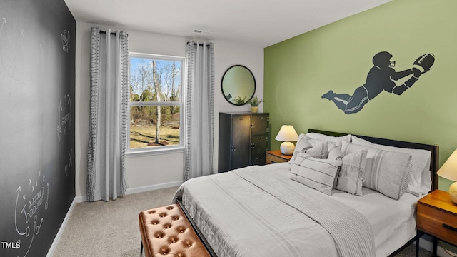 carpeted bedroom featuring visible vents, multiple windows, and baseboards