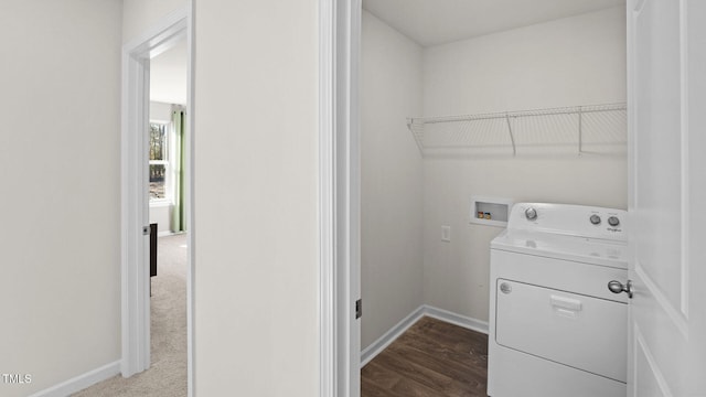 washroom featuring washer / clothes dryer, laundry area, dark wood-type flooring, and baseboards