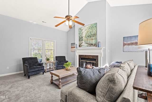 carpeted living room with high vaulted ceiling, a ceiling fan, visible vents, a premium fireplace, and baseboards