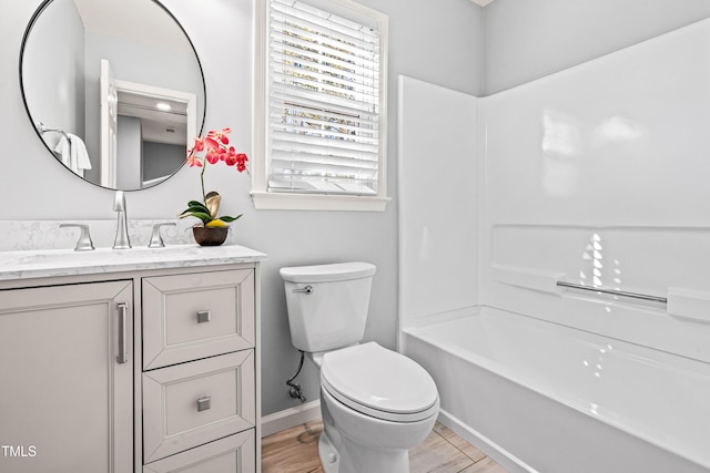 full bathroom with vanity, baseboards, toilet, and wood finished floors
