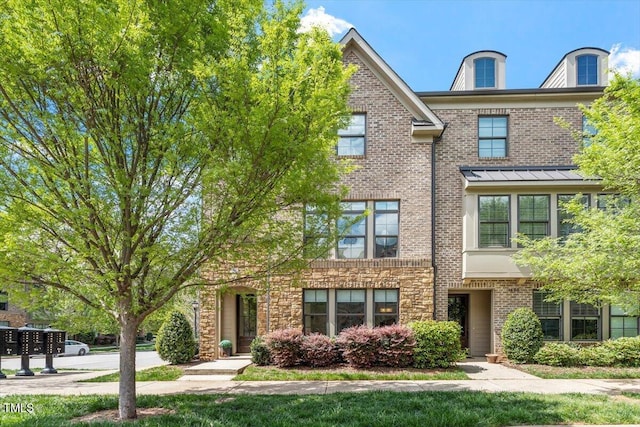 townhome / multi-family property featuring brick siding