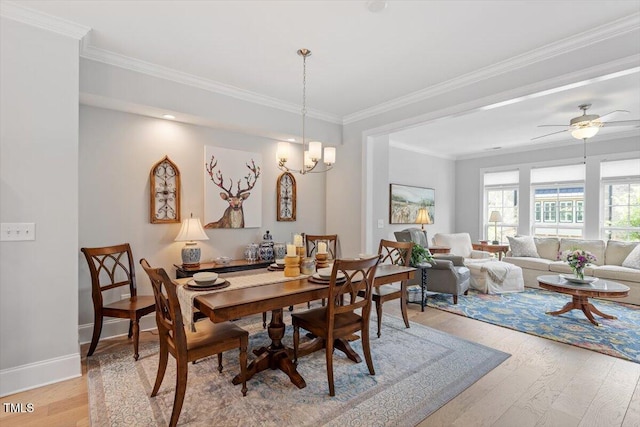 dining room featuring light wood-style flooring, crown molding, ceiling fan, and baseboards