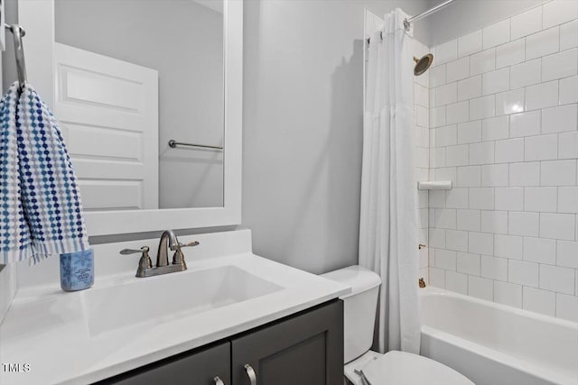 bathroom featuring shower / tub combo with curtain, vanity, and toilet