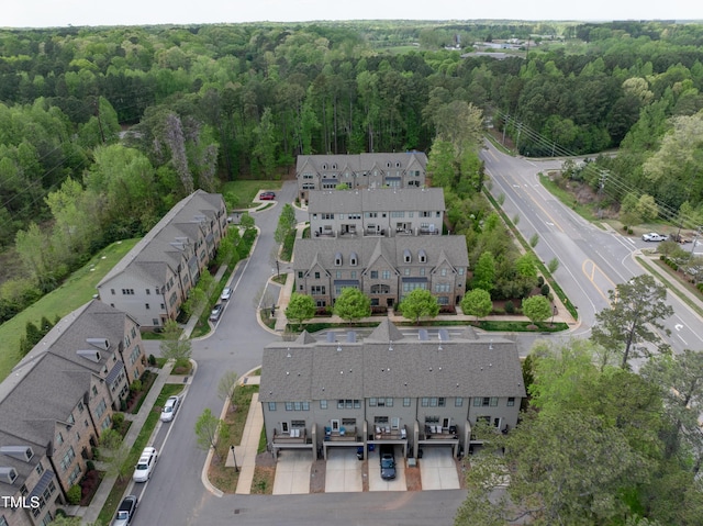 drone / aerial view featuring a wooded view