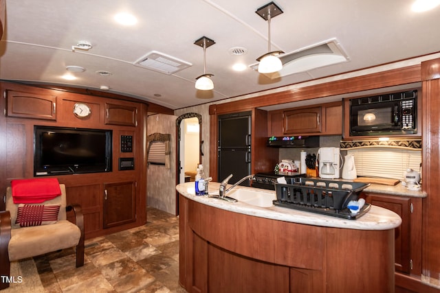 142 Blackhawk Dr, Louisburg, NC 27549 - kitchen featuring arched walkways, black appliances, a sink, decorative light fixtures, and brown cabinets