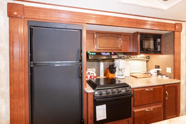 142 Blackhawk Dr, Louisburg, NC 27549 - kitchen featuring brown cabinets, light countertops, and black appliances
