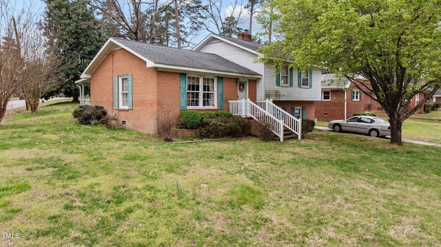 tri-level home with a chimney, crawl space, a front yard, brick siding, and a shingled roof