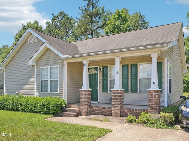 view of front of house with covered porch and roof with shingles