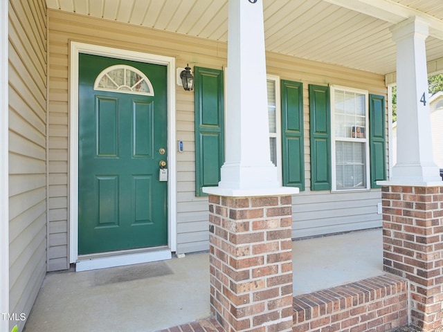 view of exterior entry with a porch