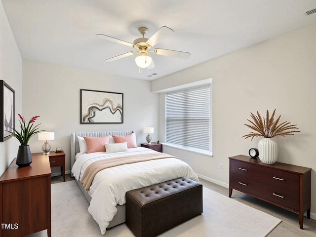 bedroom with baseboards, light carpet, and ceiling fan