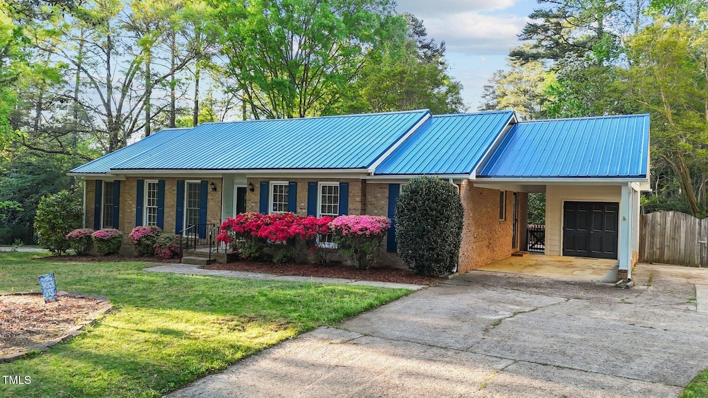 801 Silver Leaf Pl, Raleigh, NC 27609 - view of front of home with metal roof, driveway, an attached carport, and brick siding